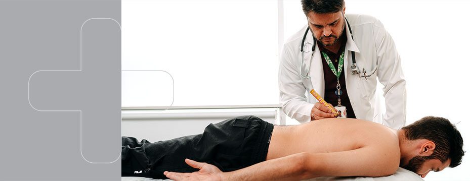 Foto de um médico examinando as costas de um paciente.